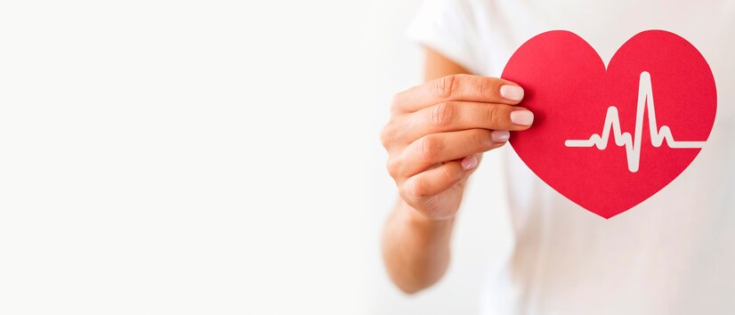 woman holding paper heart with heartbeat